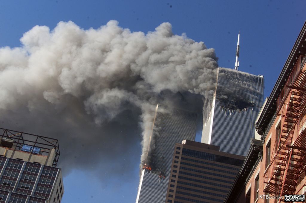 Smoke rising from the twin towers of the World Trade Center after hijacked planes crashed into the towers. Photo.