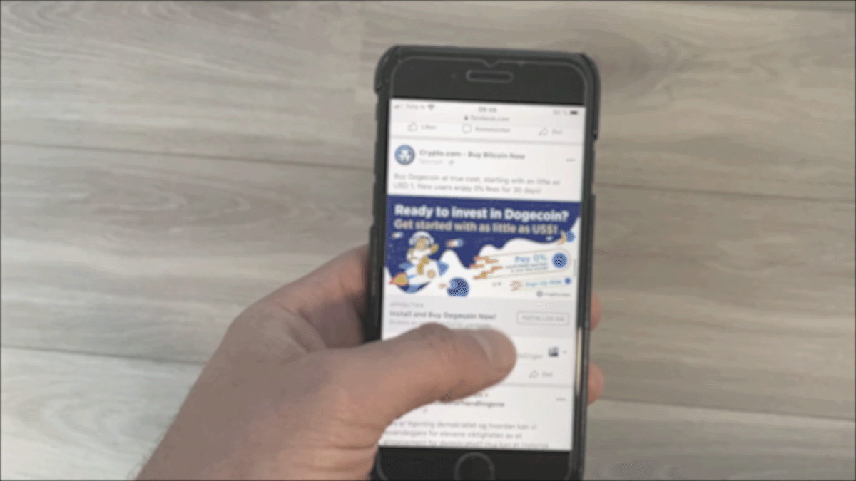 Nærbilde av en person som bruker tommelen til å skrolle gjennom en Facebook-strøm på en smarttelefon. Repeterende GIF-animasjon.