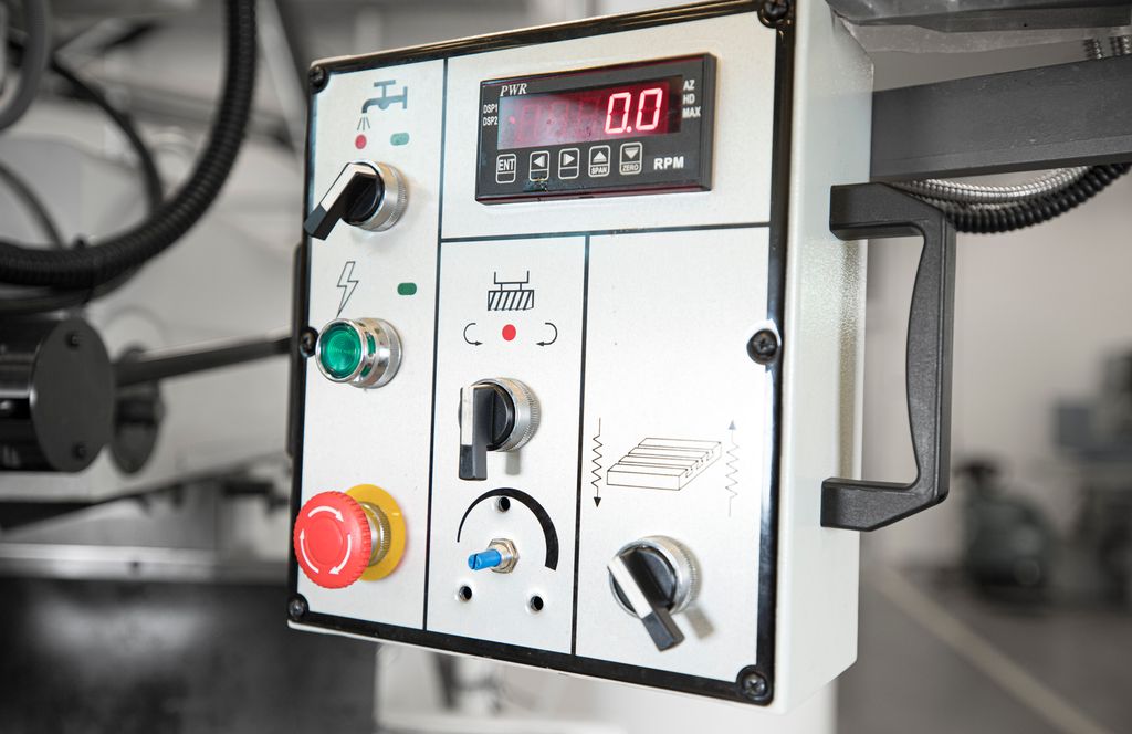 Beteningspanel med naudstoppbrytar på fres. Foto.