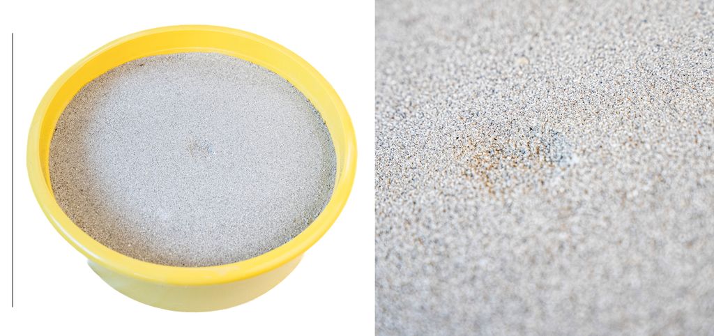 Rund plastbalje fylt med mineralstein. Foto.