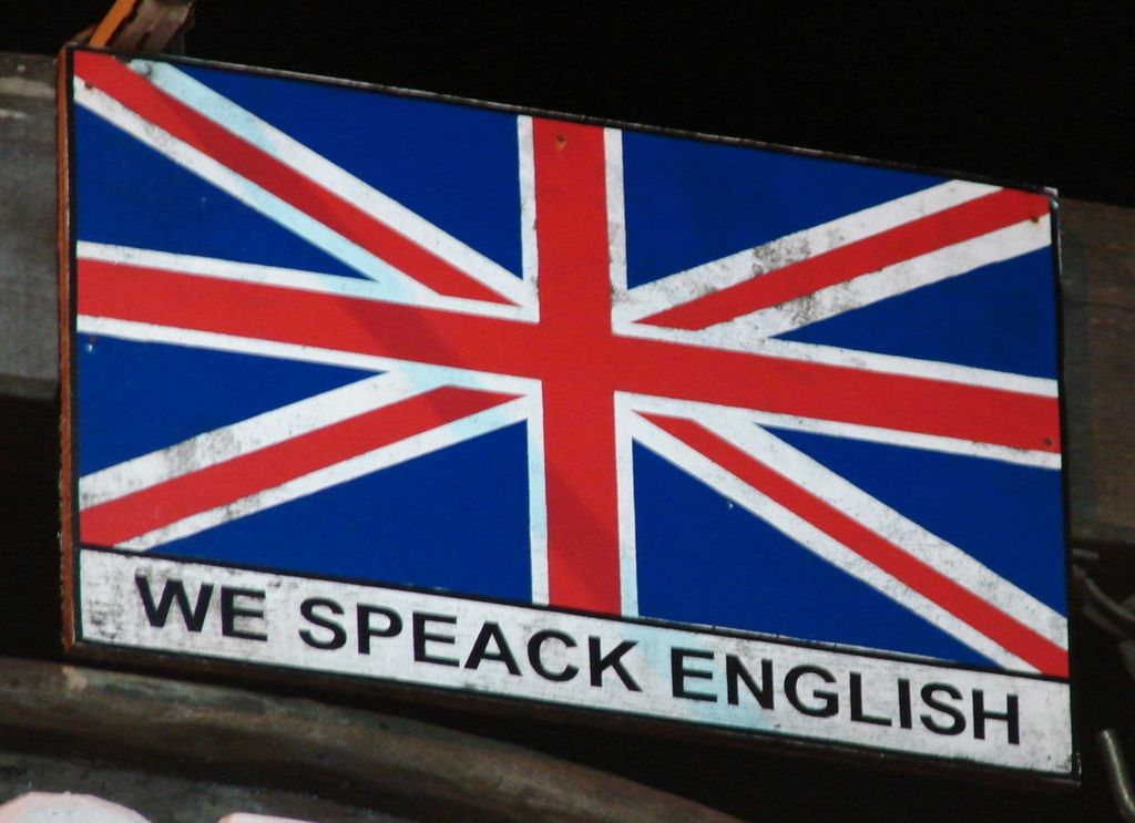 A Union Jack flag (the UK flag) with the words 'We Speack English' underneath. Photo.