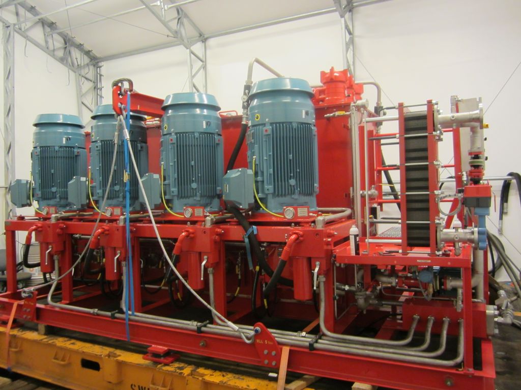 Bildet viser en rød HPU med blå motorer som leverer hydraulisk væske med trykk til hydraulisk utstyr. Foto.